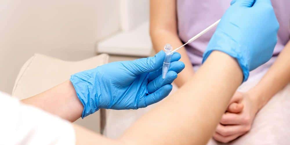 Juniper Avenue Medical Centre | Skincare and Treatments Doctor in gloves placing a sample swab into a test tube at a Point Cook clinic
